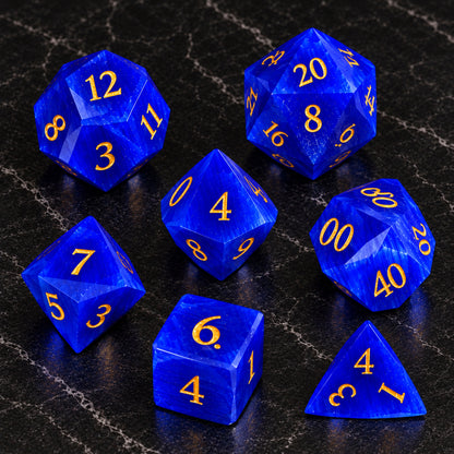 Azure Sentinel - seven-piece dice set flat lay on black marble