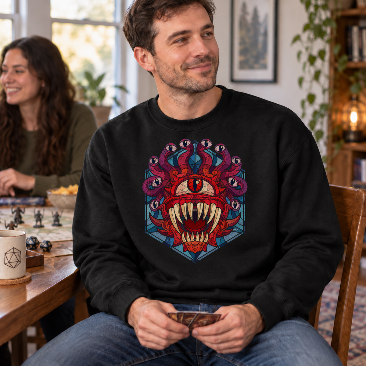 Beholder’s Gaze black DnD sweatshirt worn by a man at game night