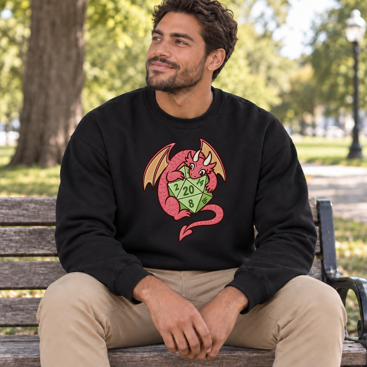 Dragon’s Lucky D20 black DnD sweatshirt worn by a man in a park