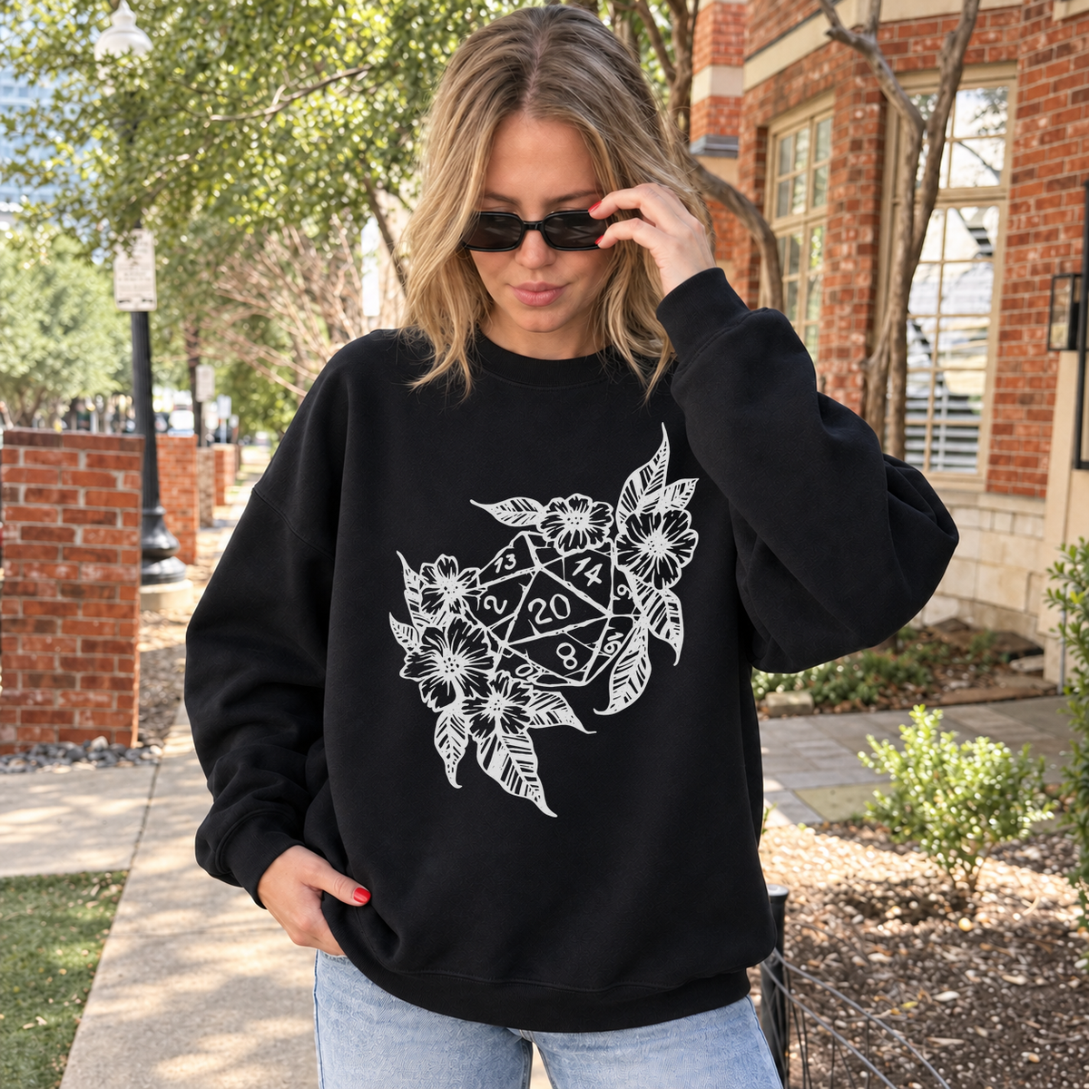 Floral Dragon D20 black DnD sweatshirt worn by a woman outdoors