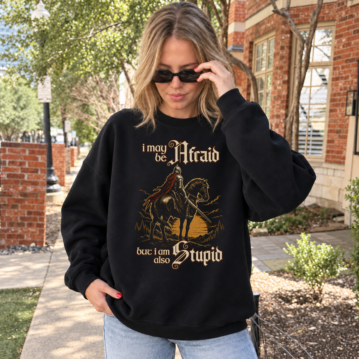Afraid but Also Stupid black DnD sweatshirt worn by a woman outdoors