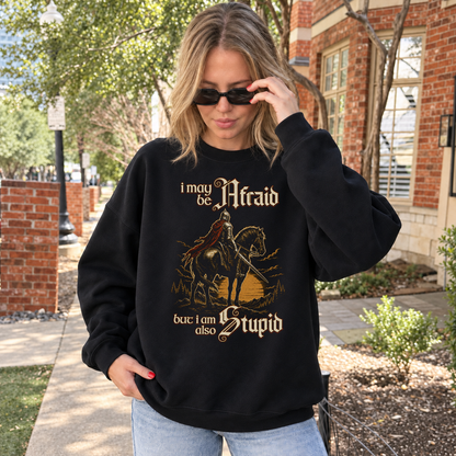 Afraid but Also Stupid black DnD sweatshirt worn by a woman outdoors