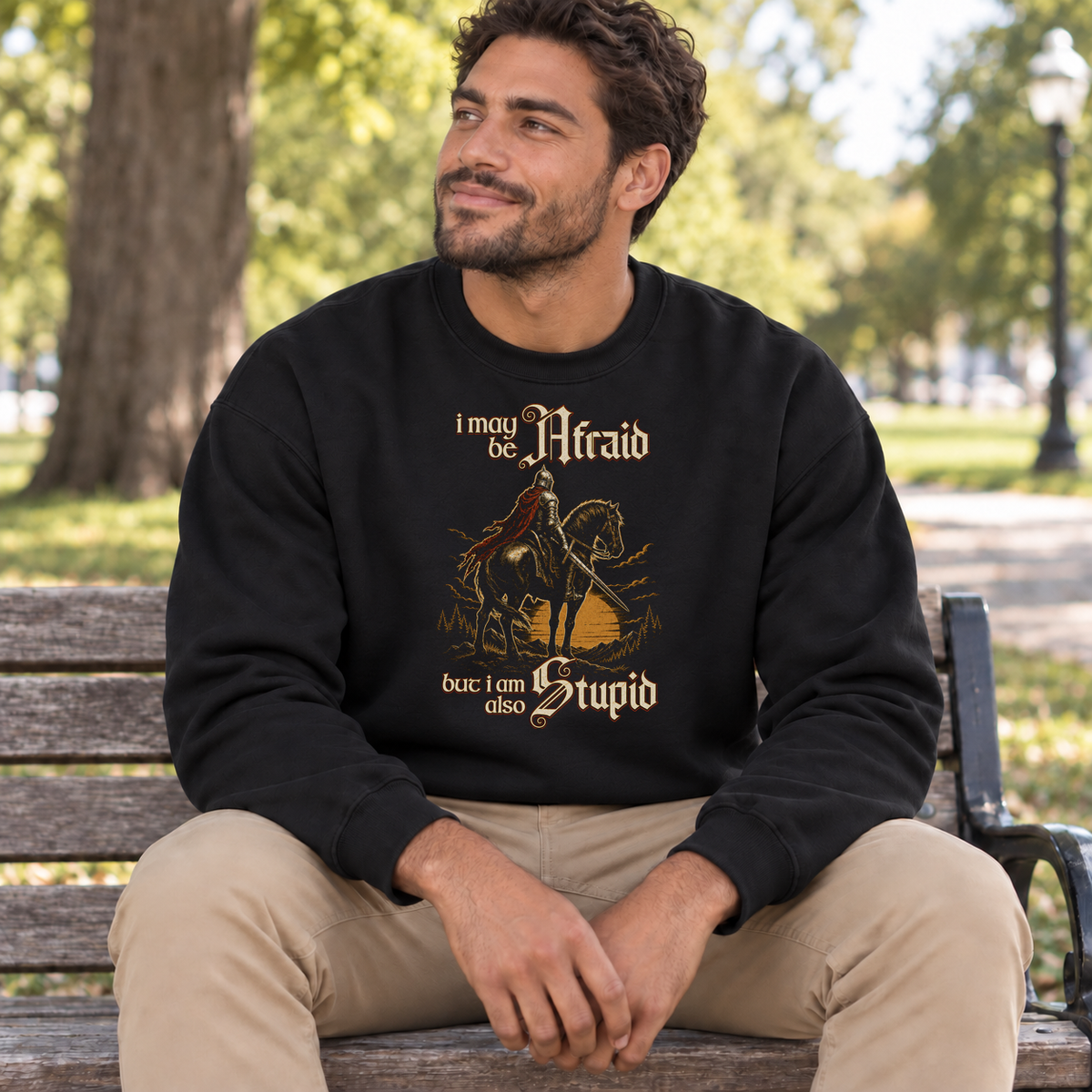 Afraid but Also Stupid black DnD sweatshirt worn by a man in a park