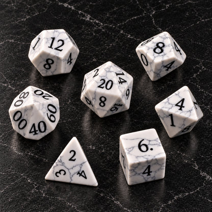 Winterweb Relic - seven-piece dice set flat lay on black marble
