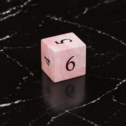 Prismrose Oracle - D6 gemstone die on black marble