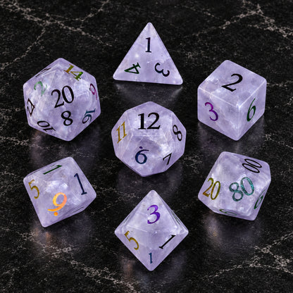 Violet Stormglass - seven-piece dice set flat lay on black marble
